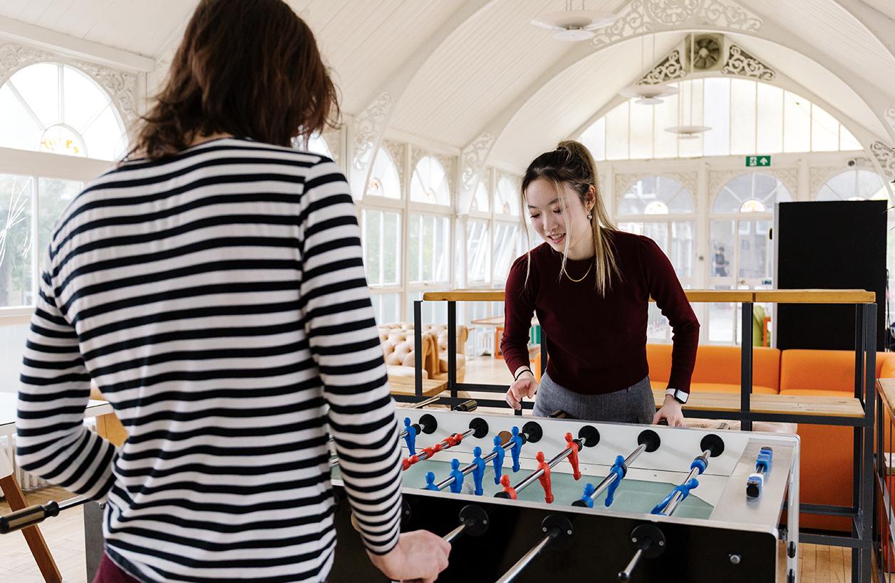 Students playing table football together