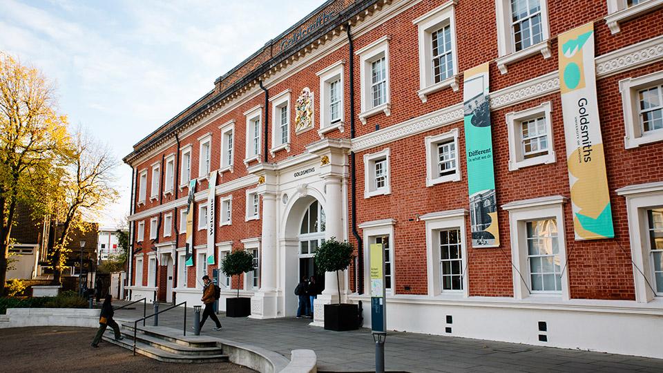 The entrance of the Richard Hoggart Building, showing students entering the building and welcome banners.