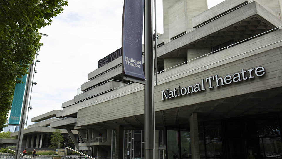 Exterior of National Theatre with sign in foreground
