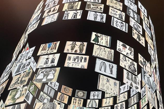 A digital screen showing lots of images of historical clothing in a spiral