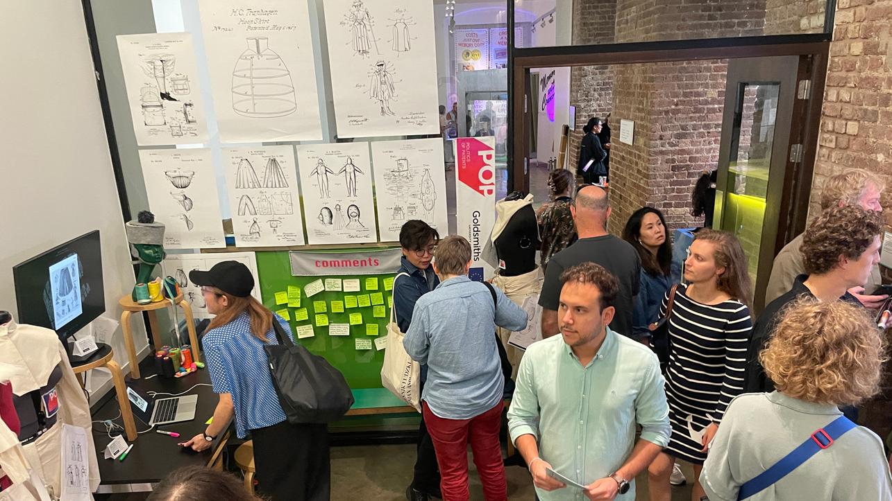 People walking through a busy exhibition space