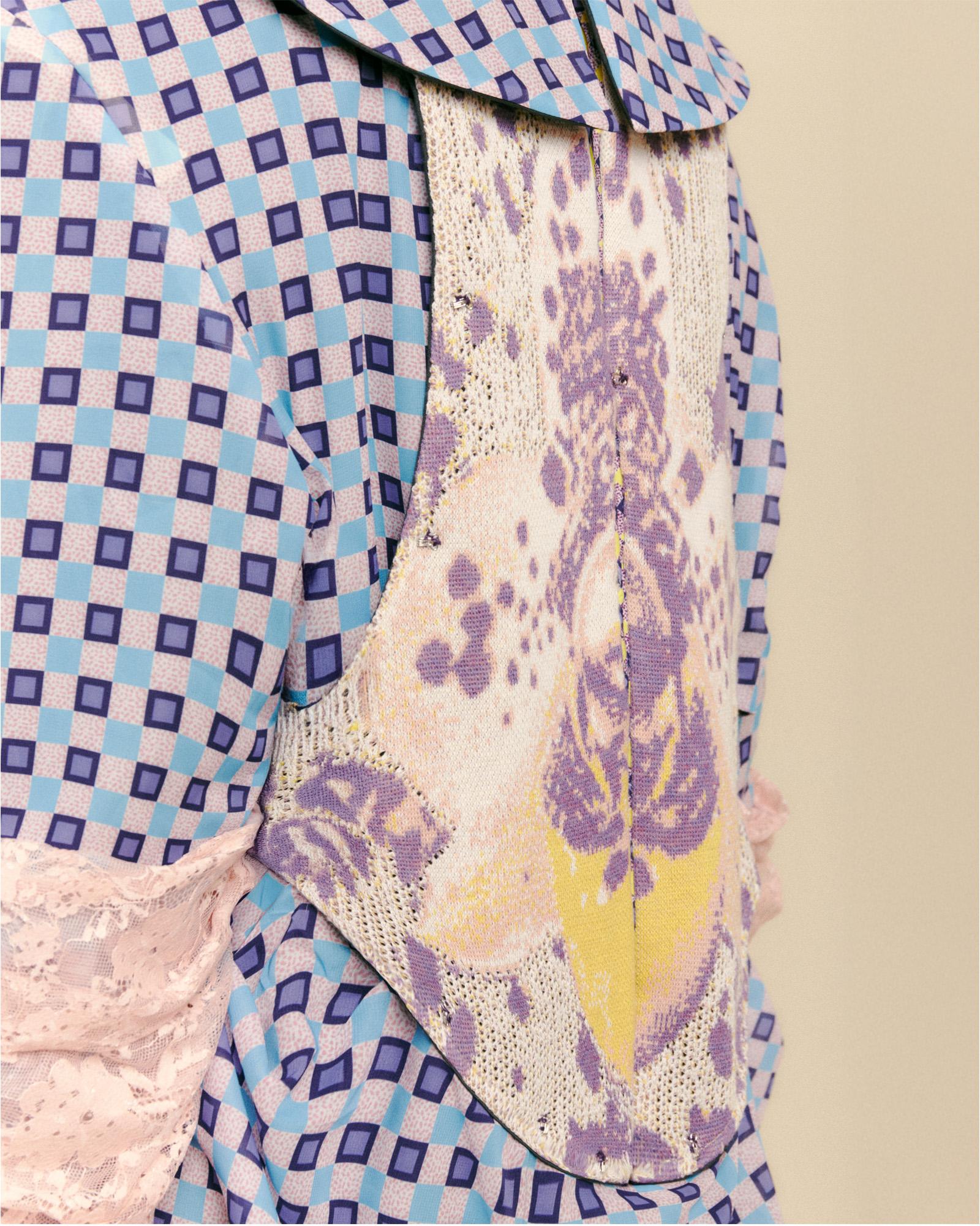 A textile work, the image shows the back of a finely detailed and embroidered garment.