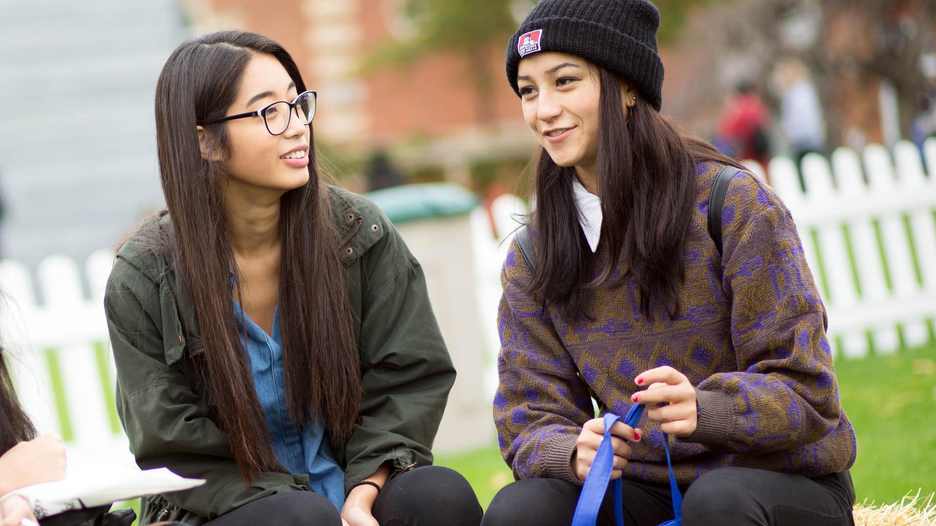 Two students having a conversation outside