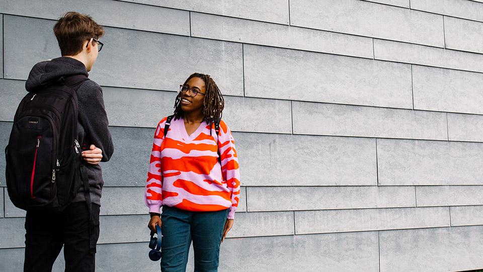 Two students talking on campus