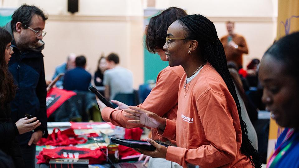 Student ambassador greeting guests at Open Day