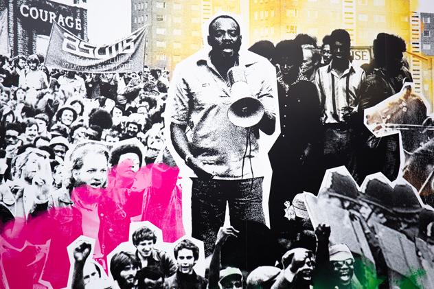 A close-up of the Battle of Lewisham mural, featuring a collage of archive photography including a man speaking into a megaphone, and groups of protestors