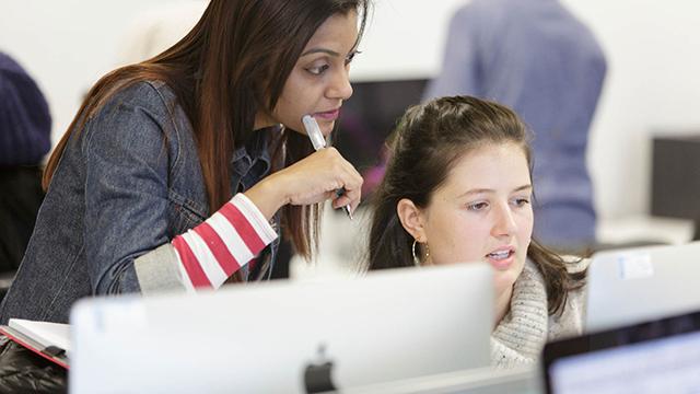 Two people working at a computer