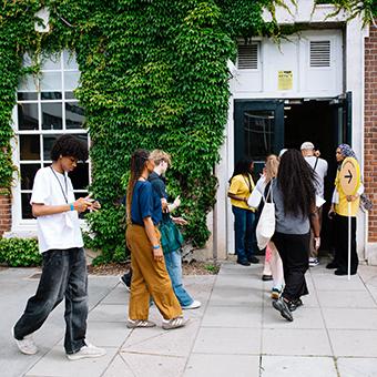 A group of people walking into the Richard Hoggart Building